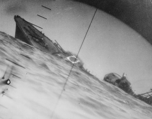 Looking through the periscope of either the USS Wahoo or Nautilus, a torpedoed Japanese destroyer sinks