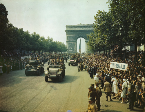 Parisians line the Champs-Élysées as American tanks and half-tracks stream past the Arc de Triomphe