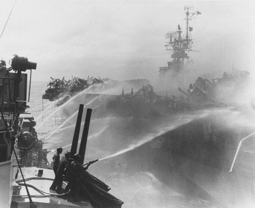 The USS Birmingham alongside the USS Princeton, attempting to put out fires that were the result of a Japanese air attack. An explosion from the Princeton killed 200 men from the Birmingham