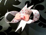 2.5in x 1in white bow with pink polka dots