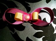 pink bow with yellow and pink ribbon and pink gem