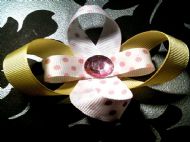 yellow bow with white ribbon and pink polka dots and pink tint gem