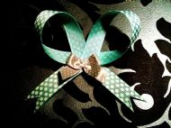 green bow with white polka dots and silver mini bow