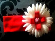 red hairband with red bow on white flower