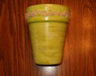 Green, hand painted clay pot with beading.
