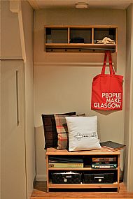 Coat rack with shelves providing loads of pamphlets and information on the area.
