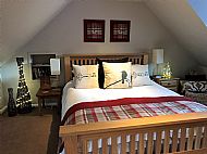 Bedroom has a kingsize bed with dimmable roof lights