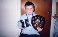 A junior with competition trophies