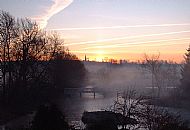 Feb 2008 - White Bridge over a misty river, with the sunrise silhouetting Achurch church.