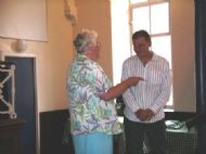 church secretary presents baptismal certificate
