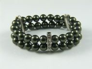 SWAROVSKI PEARL CUFF ON ELASTIC WITH PLATED METAL BARS WITH INLAID CRYSTALS IN DARK GREEN
