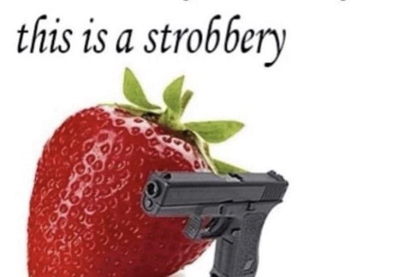 A strawberry holding a gun, above is there’s the line: this is a strobbery