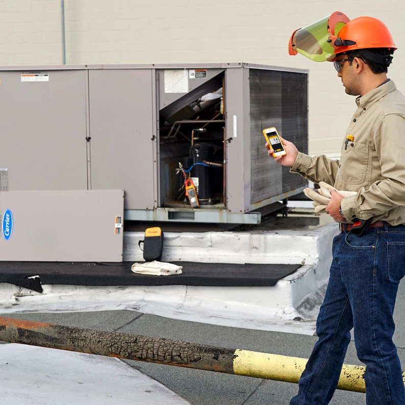 HVAC Engineer using the FLUKE 902 FC HVAC Clamp Meter on a heating, ventilation, and air conditioning job