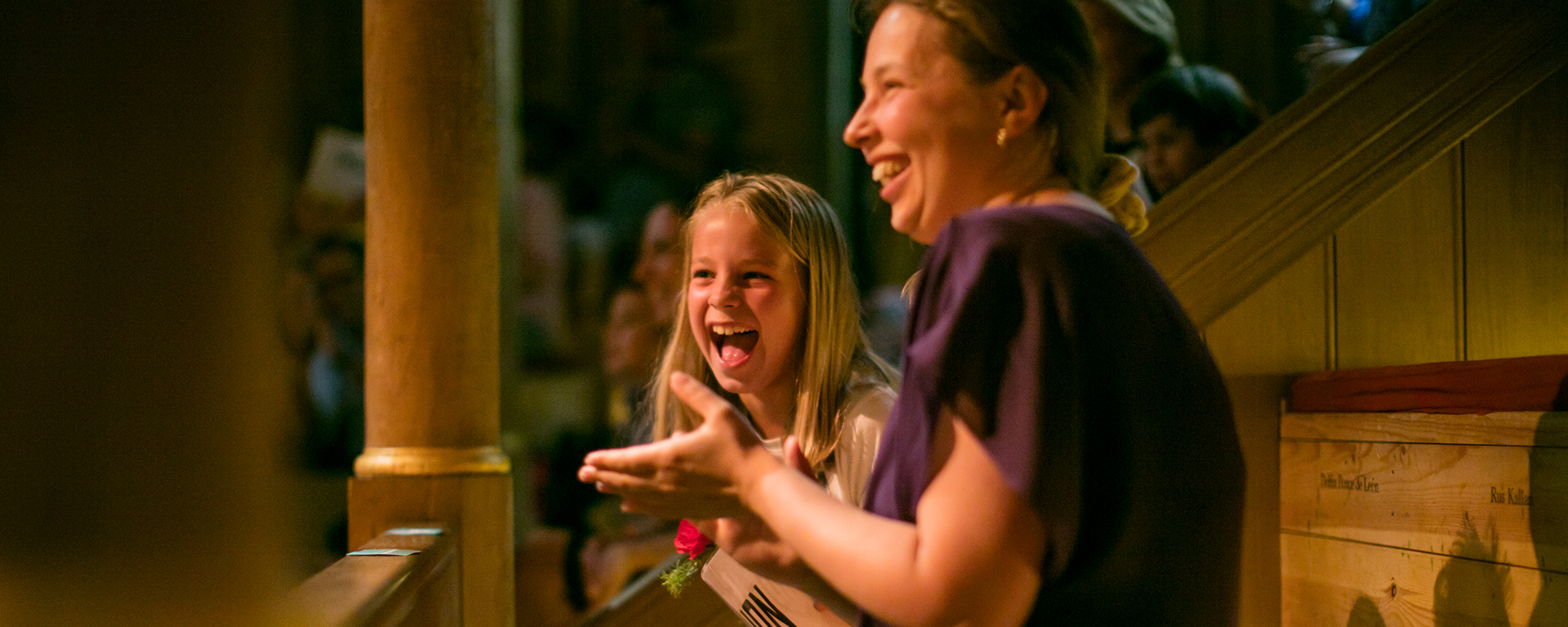 Henry-2019-storytelling-mastheadimage An adult and child clapping whilst watching a storytelling at the Sam Wanamaker Playhouse.