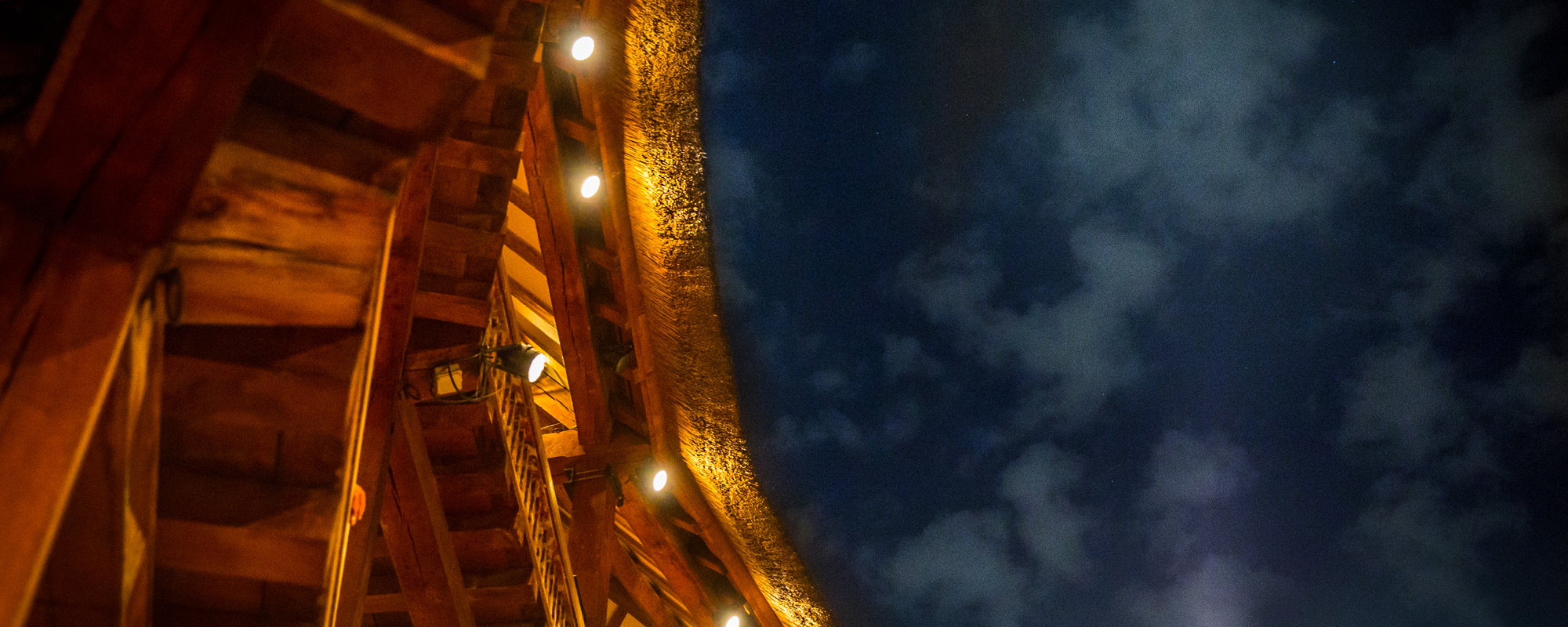 Midnight Matinée 2021 A close up of the corner of a roof of an open-air theatre, that shows an open sky and wooden beams