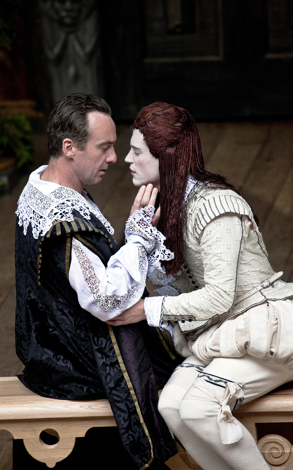 Twelfth Night 2012 Shakespeare's Globe Two actors lean in towards each other, one's hand raised towards the other's face