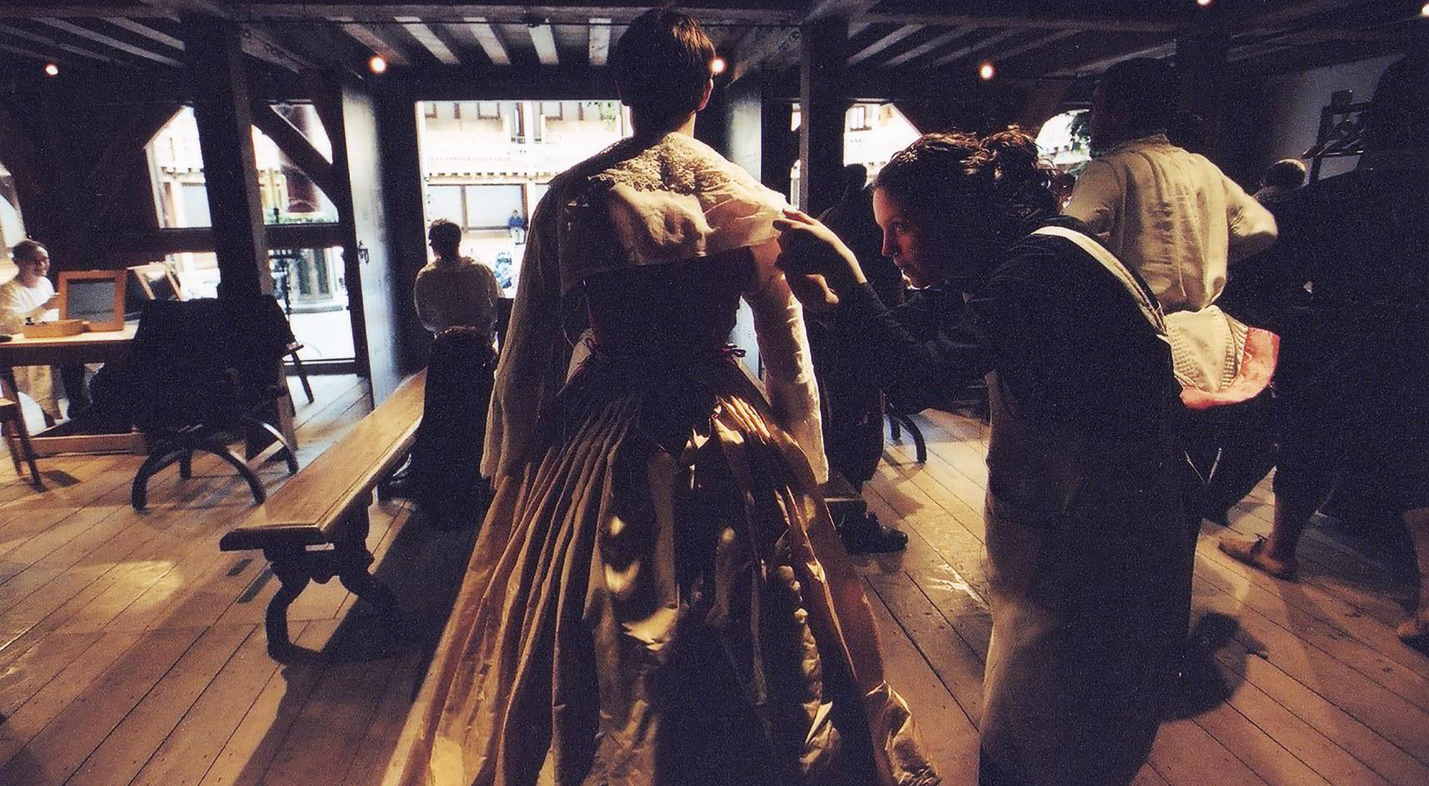 Costume flush Twelfth Night Shakespeare's Globe A backstage view of the Globe Theatre, wear a woman helps a man get in to his Elizabethan dress.