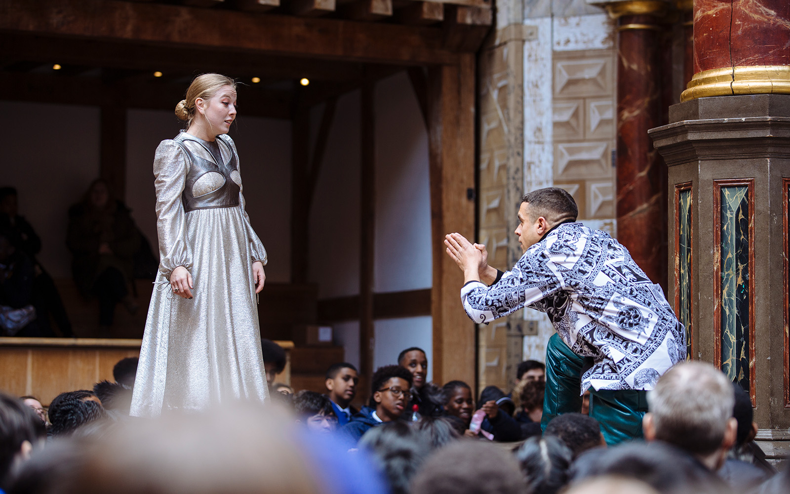 Globe Magazine Article Love in Isolation Romeo and Juliet 2019 Such Stuff S5 E3 A man kneels before a woman, his hands clasped together