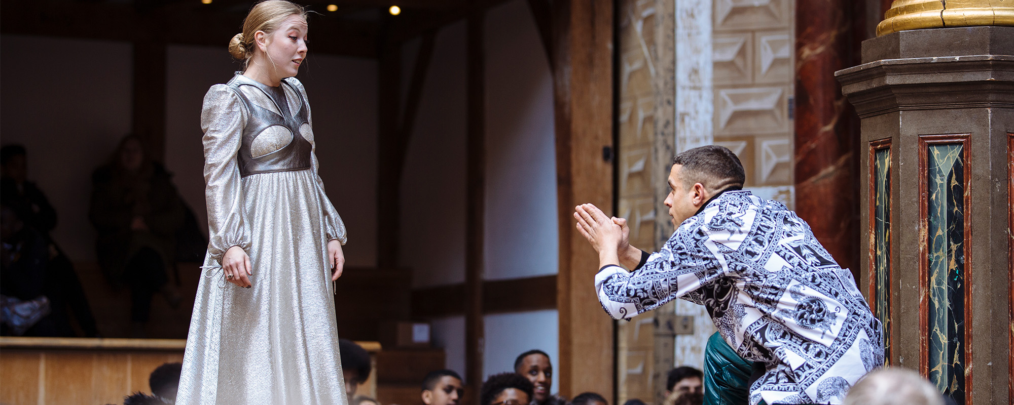 Love in Isolation Romeo and Juliet 2019 Such Stuff S5 E3 Masthead Romeo kneels to Juliet upon meeting her, his hands are clasped together