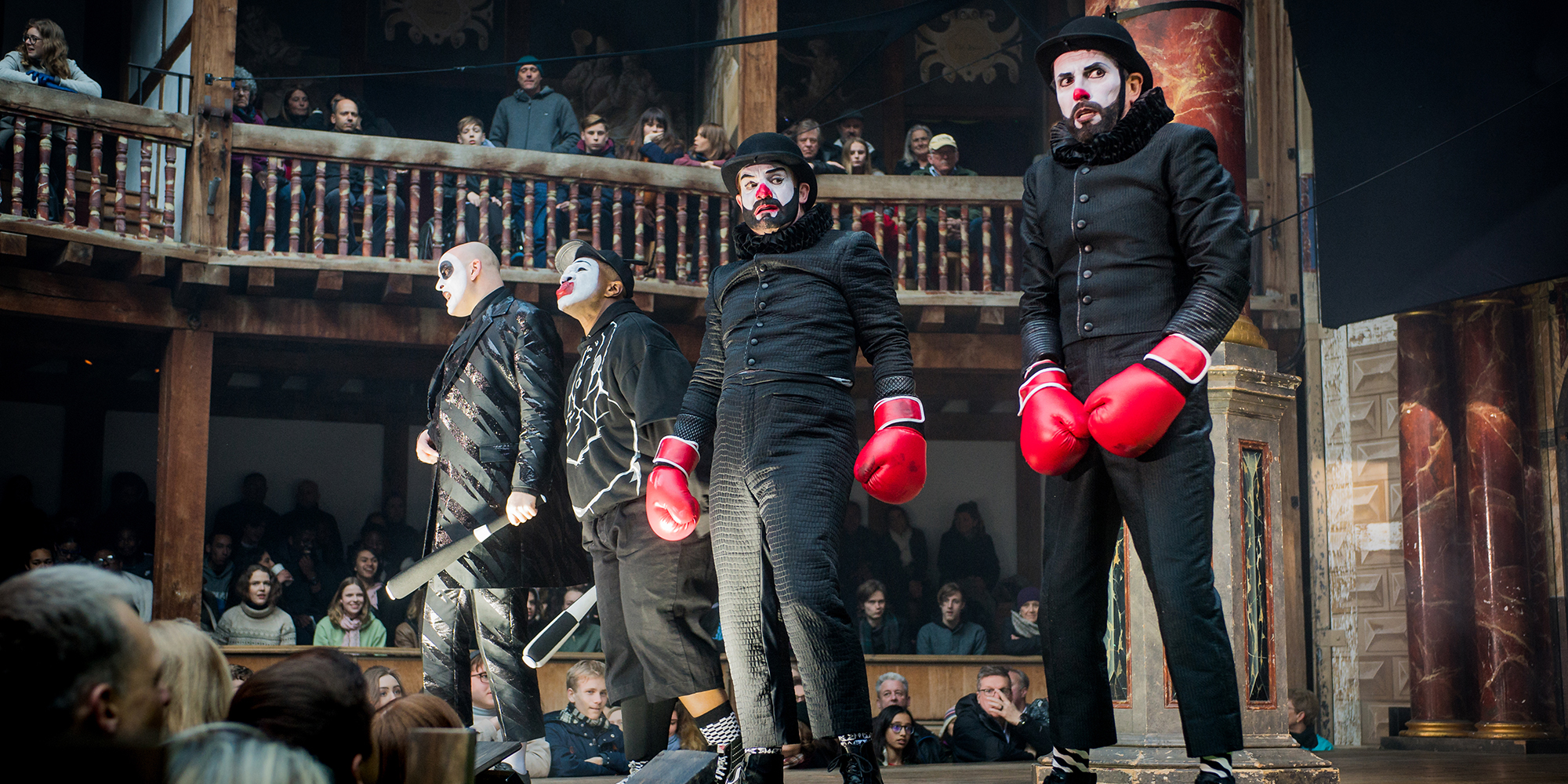 Romeo and Juliet - William Shakespeare - Shakespeare’s Globe - 21 April 2017Director - Daniel KramerDesigner - Soutra GilmourChoreographer - Tim ClaydonLighting - Charles Balfour Four people wearing black, in clown makeup, and wearing red boxing gloves.