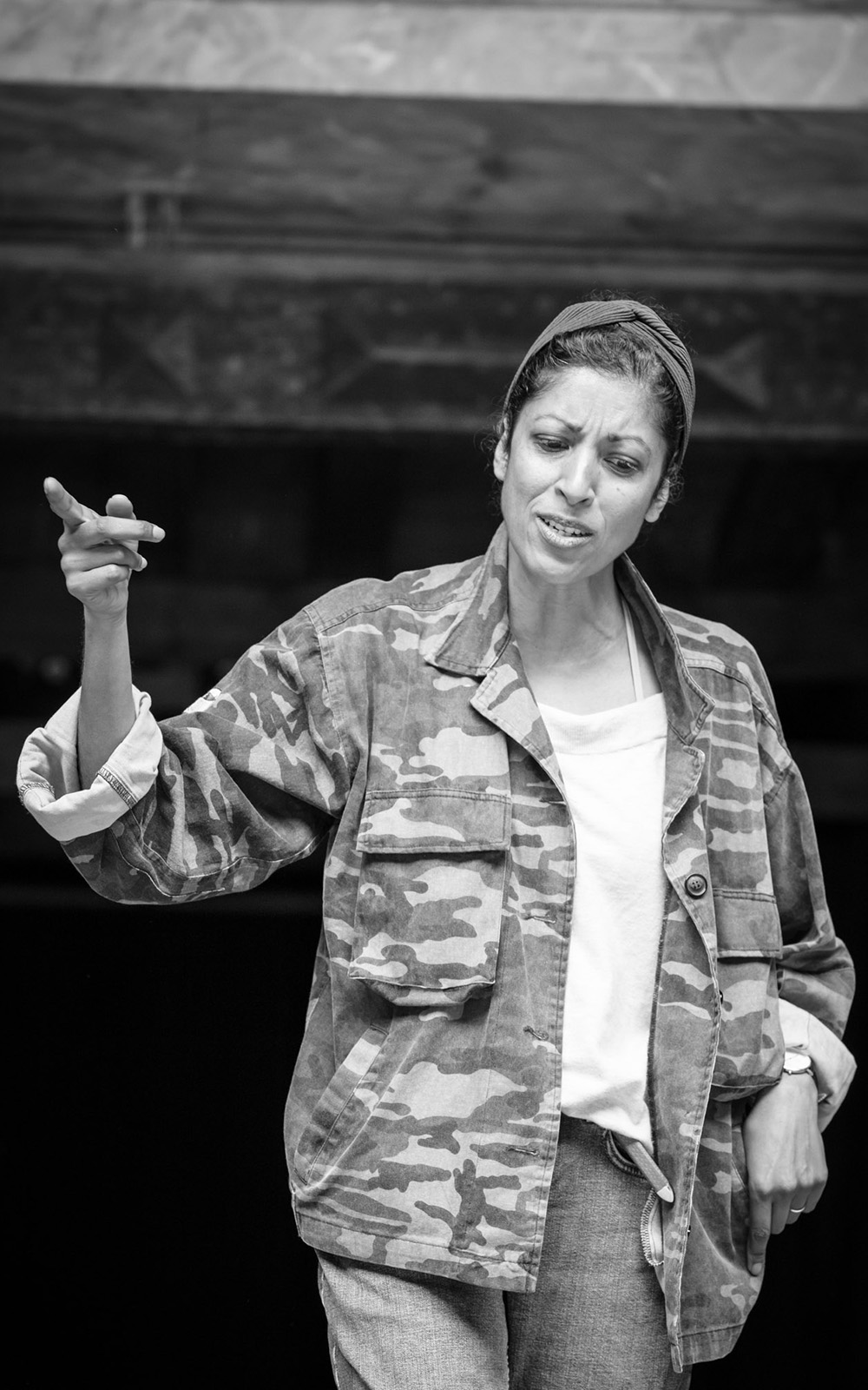 Hermione The Winter's Tale Globe 2018 A woman wearing a green cargo jacket looks down disgruntled whilst pointing her finger out.