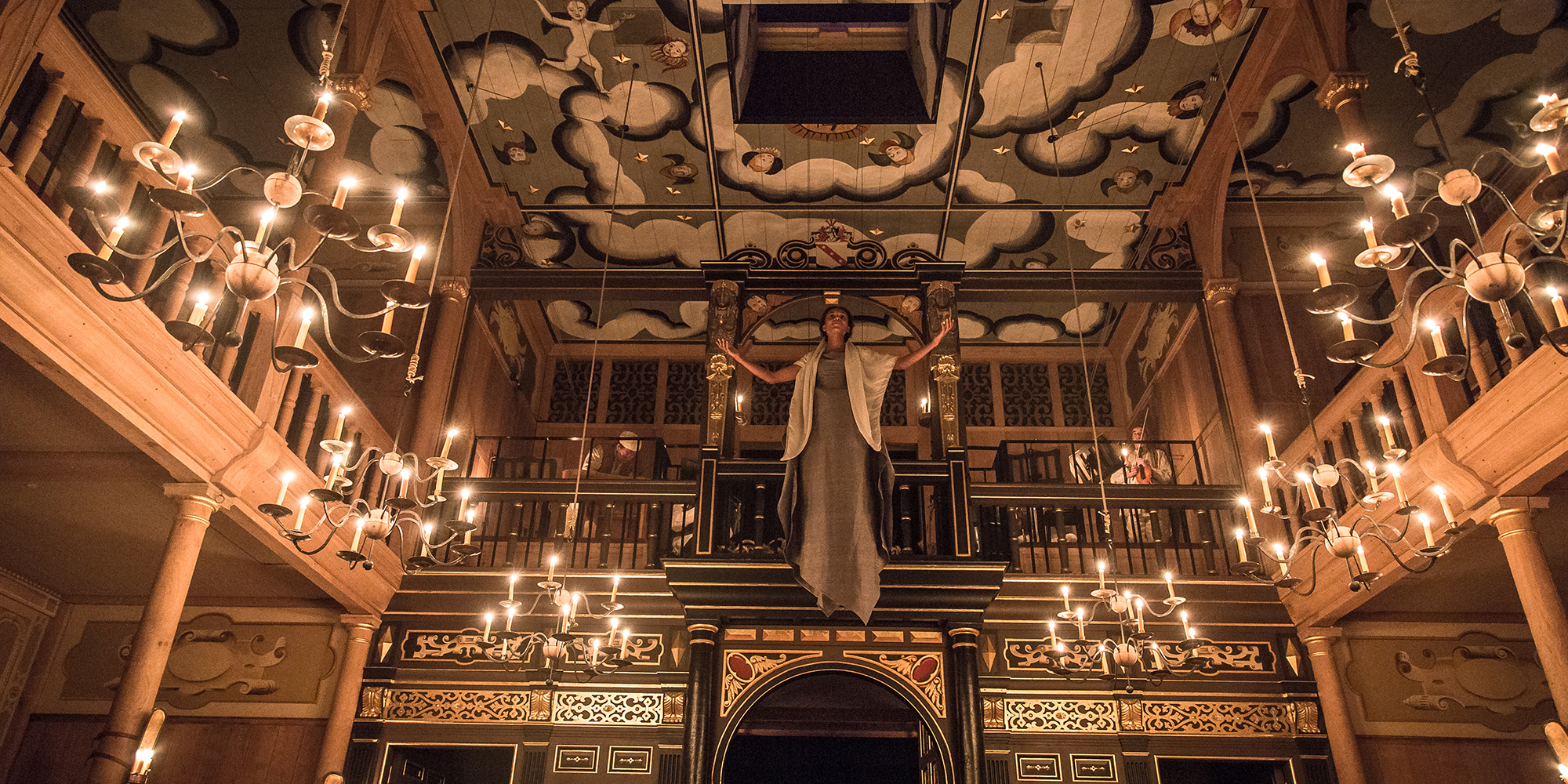 Pericles Sam Wanamaker Playhouse 2015 A woman descends from a trapdoor in the painted heavens of the Sam Wanamaker Playhouse, which is lit by candlelight.