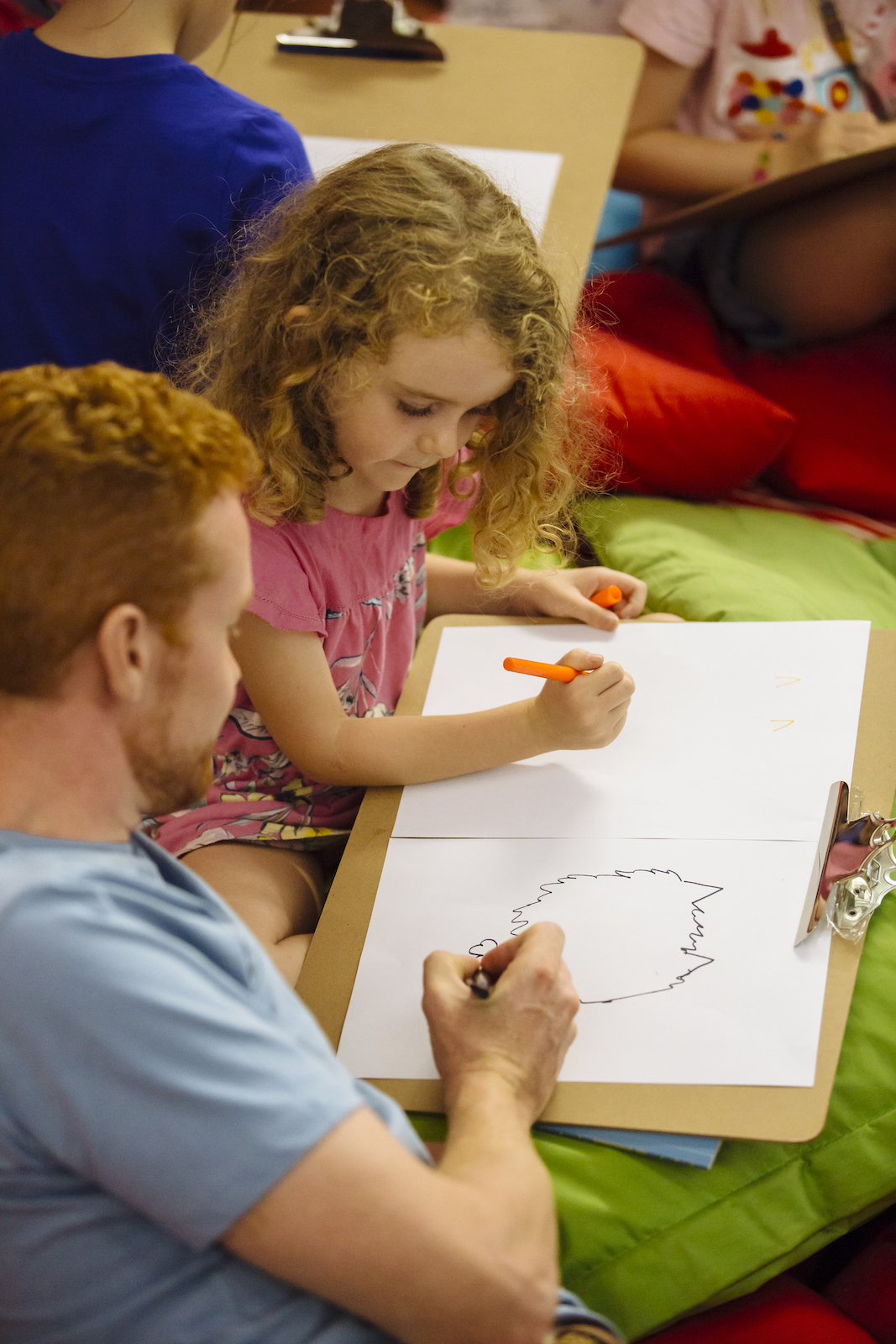 Teaching Resources A man helps his daughter draw on a piece of paper