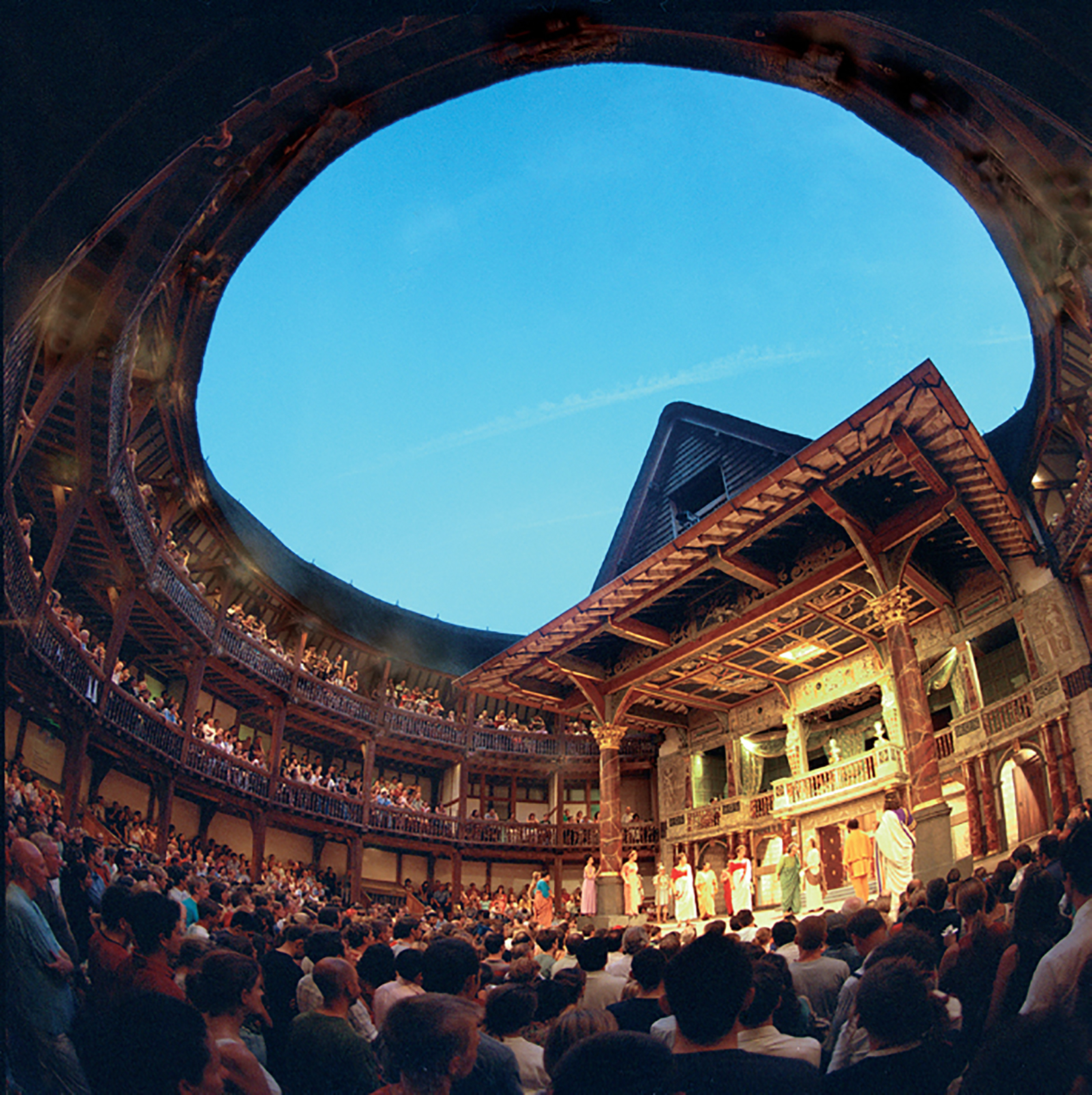 Globe Theatre interior fish eye Shakespeare's Globe A circular inside photograph of a timber structure theatre, filled with audiences.