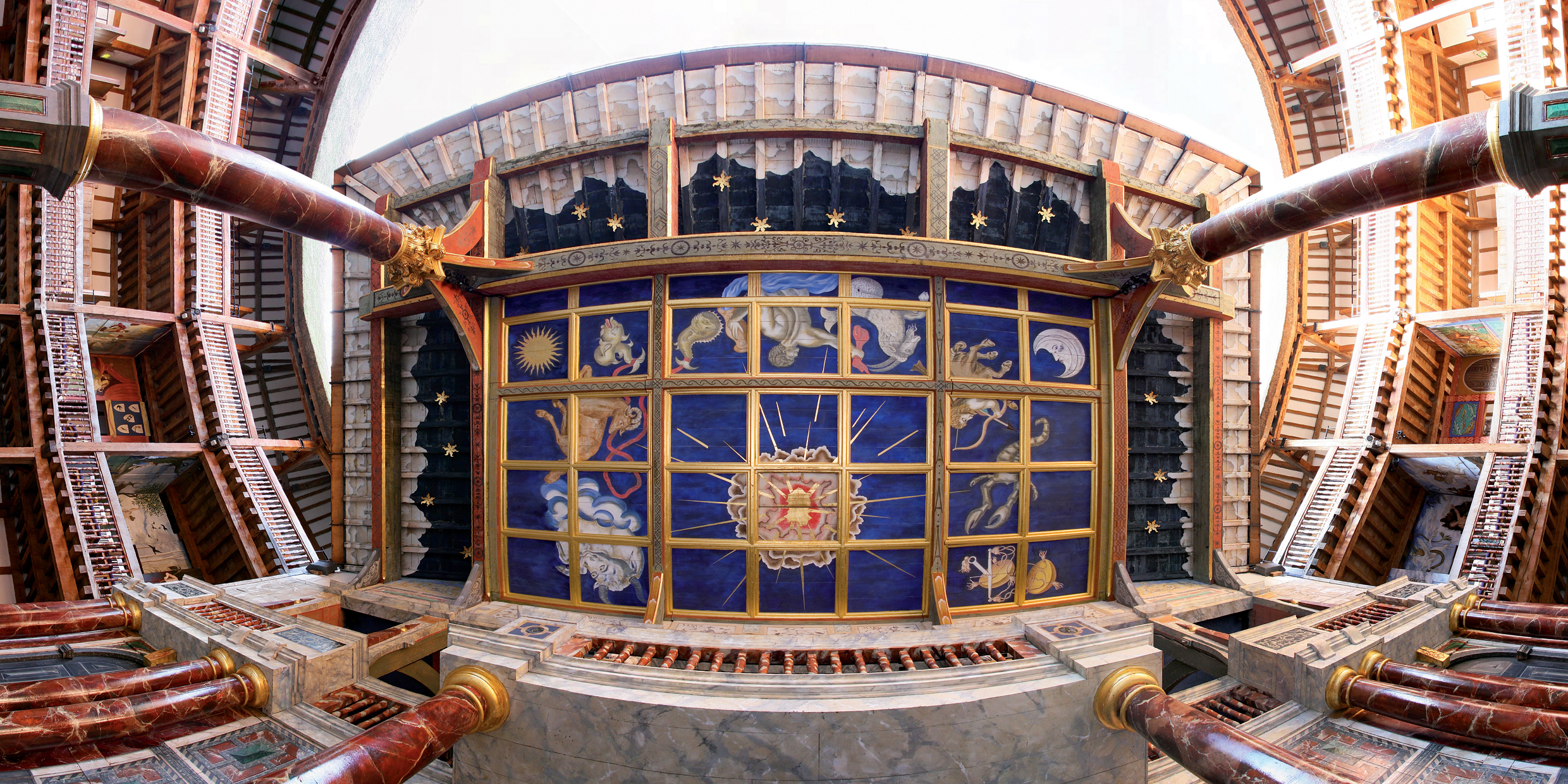 Under the Globe Theatre Heavens A shot directly underneath the Heavens of the Globe Theatre, looking up at a painted blue ceiling with stars, sun, moon and signs of the zodiac.