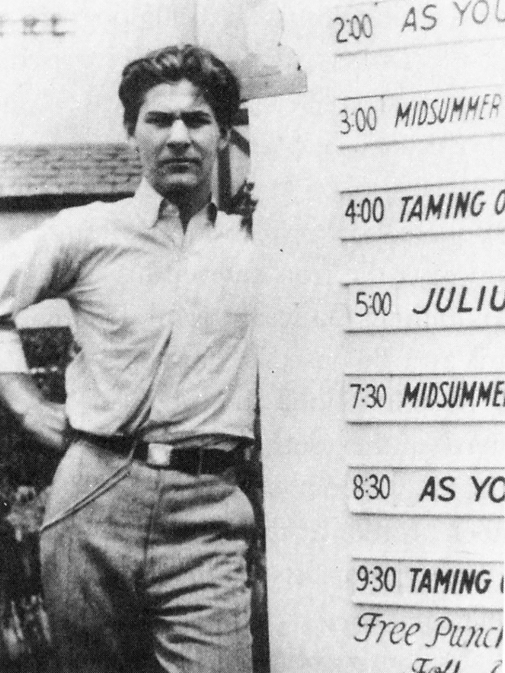 Sam Wanamaker Cleveland Ohio Shakespeare's Globe A man stands next to a board with a list of play titles.