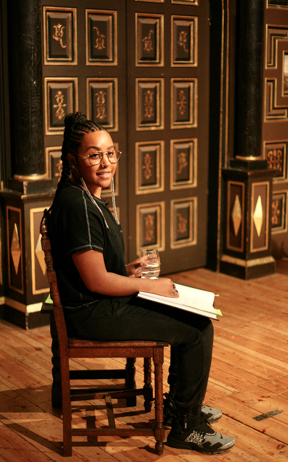 Globe Magazine Article Romeo and Juliet Shakespeare and Race An actor wearing glasses sits on a chair