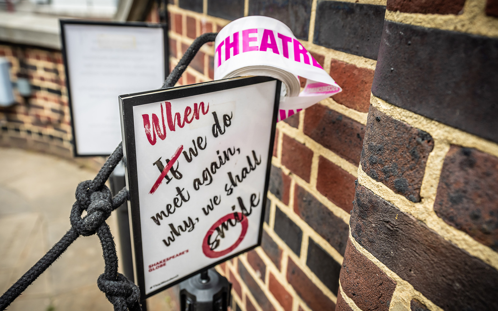 Scene Change Globe-12 A small sign reads: When we do meet again, why we shall smile