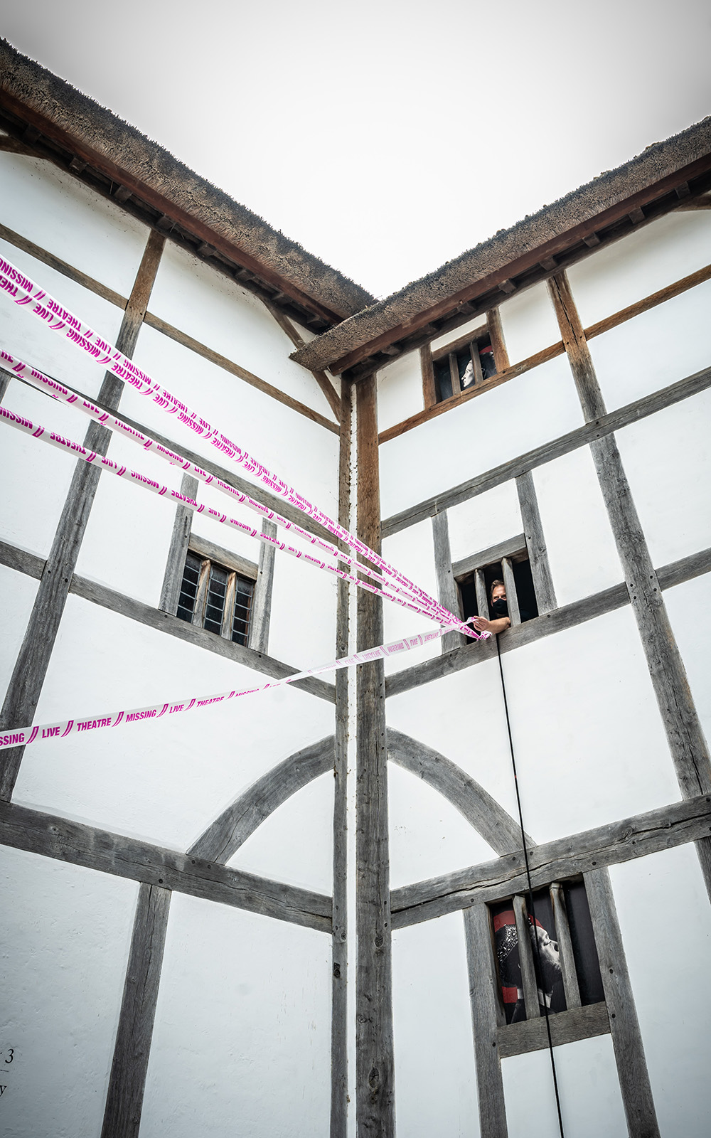Scene Change Globe-205 The white wattle and daub of a theatre wall, with white and pink tape crossing infront.