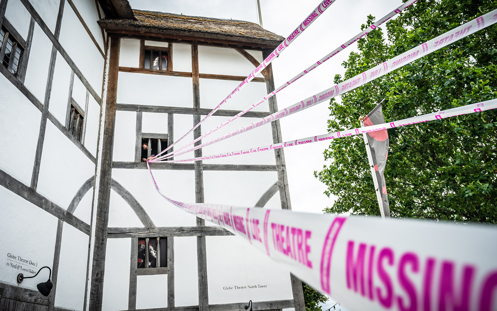 Scene Change Globe-224 The white wattle and daub of a theatre wall, with white and pink tape crossing infront.