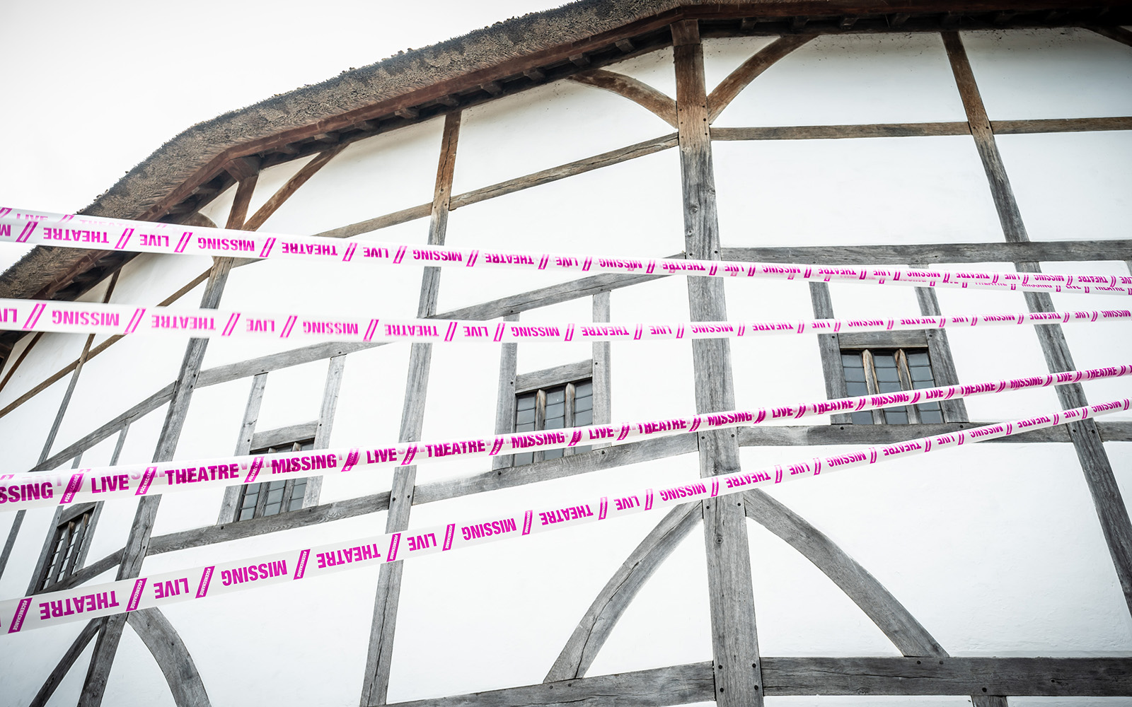 Scene Change Globe-95 The white wattle and daub of a theatre wall, with white and pink tape crossing infront.