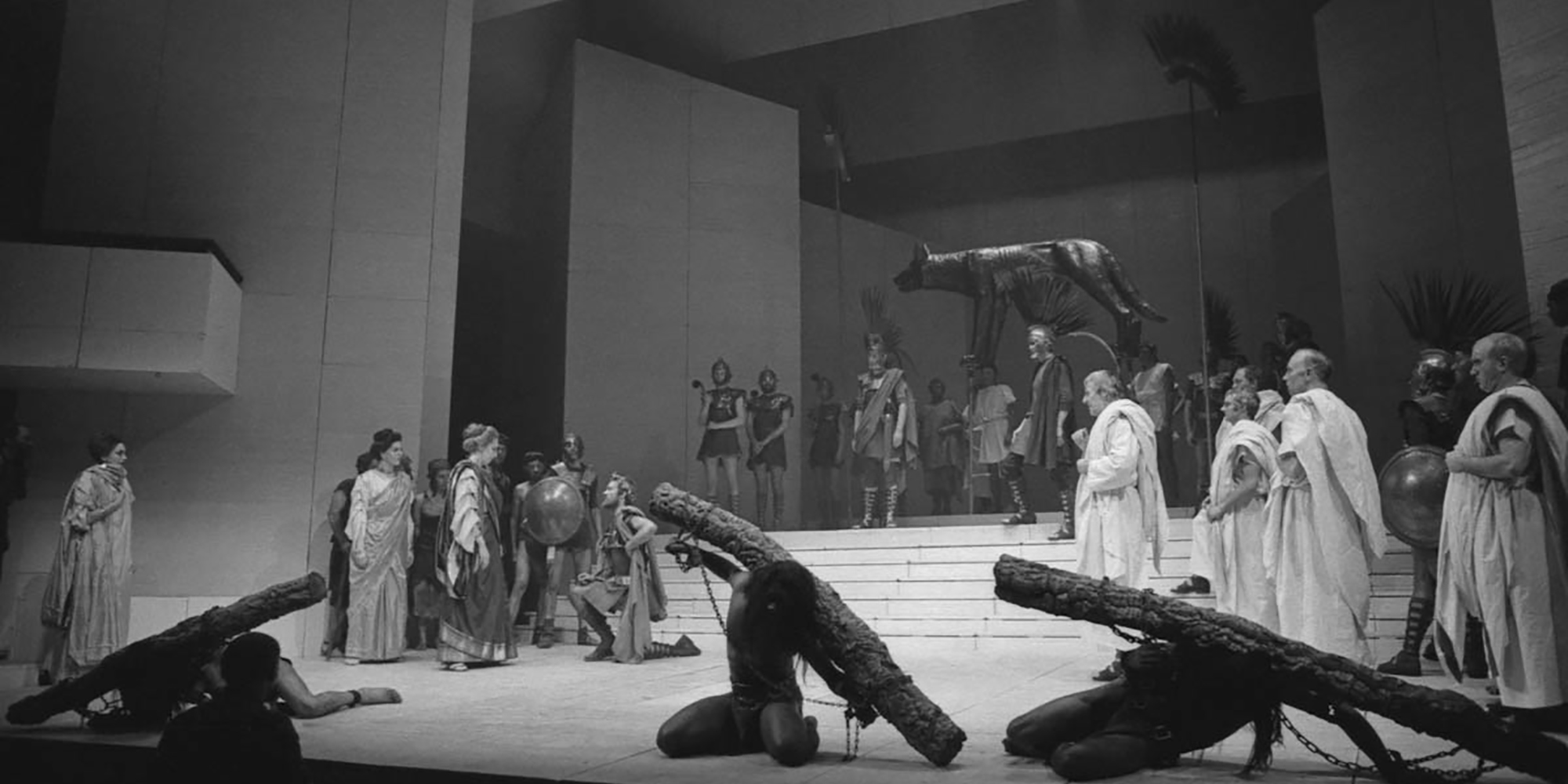 Coriolanus RSC 1972 Joe Cocks Studio Collection Shakespeare Birthplace Trust Black and white photograph of a proscenium stage, with a large group of actors standing in Roman garb: white tunics and robes, with plumed helmets.