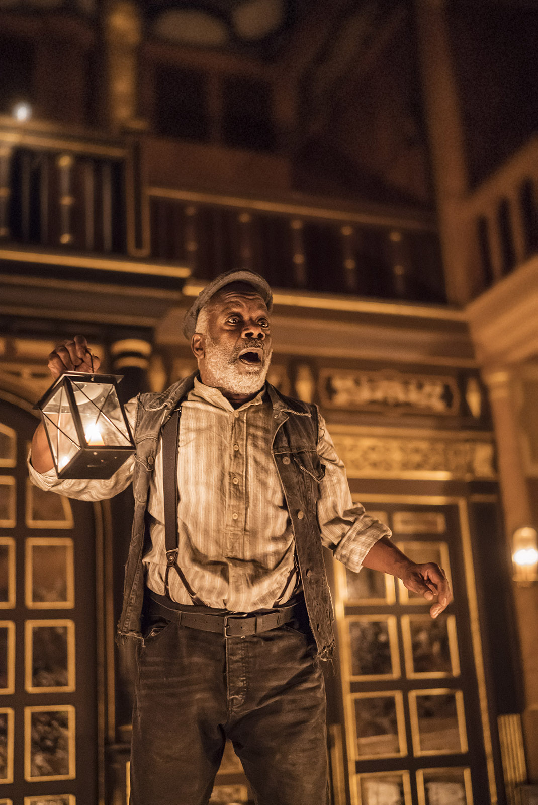 Macbeth 2018 Sam Wanamaker Playhouse A man holds a candle lantern, gasping out to the audience