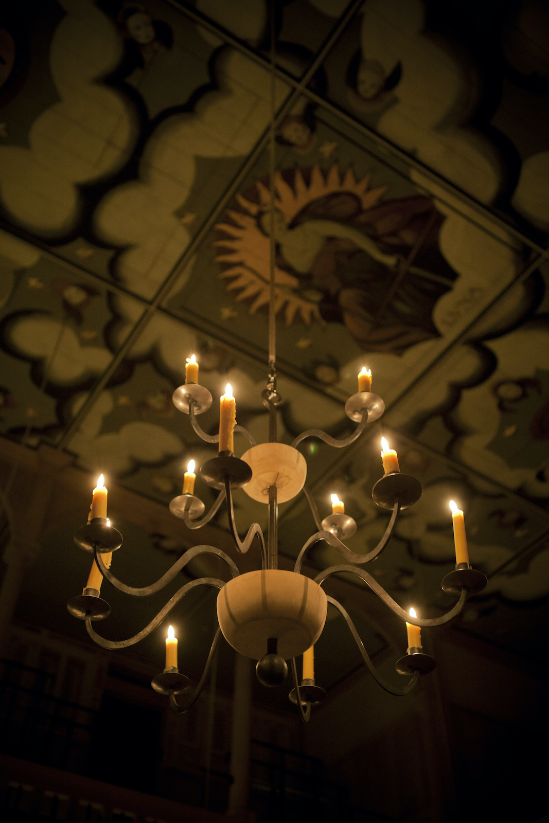 Sam Wanamaker Playhouse Pete Le May A lit candelabra hangs from a decorated ceiling.