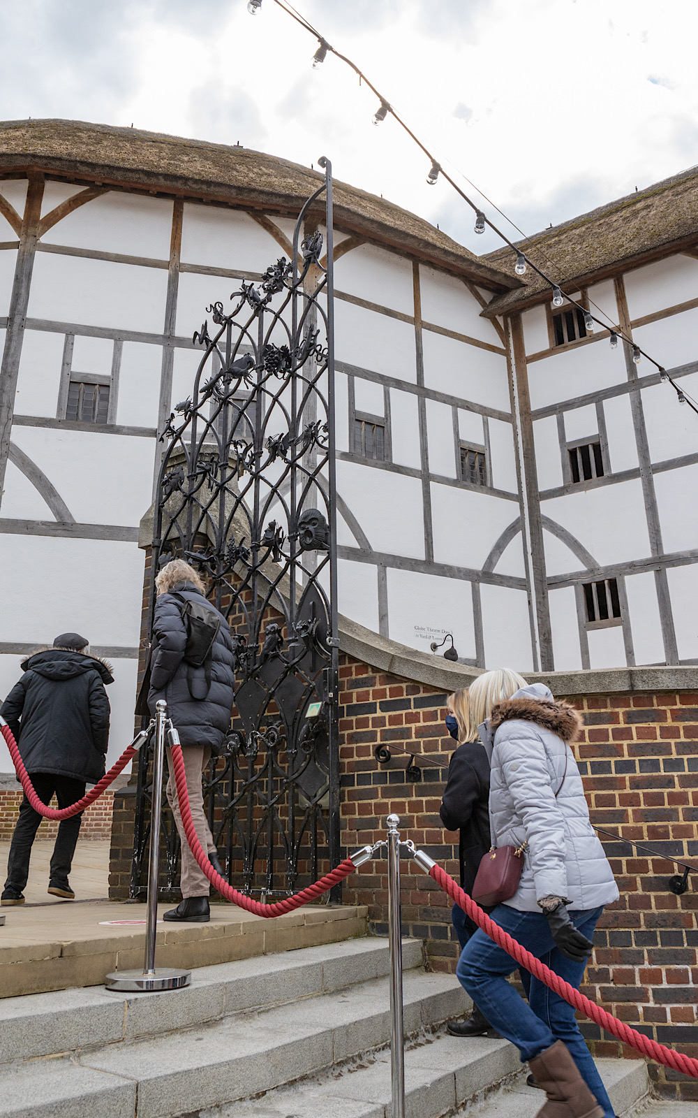 Guided Tours 2021 Pete Le May People walk up stone steps through a black metal gate