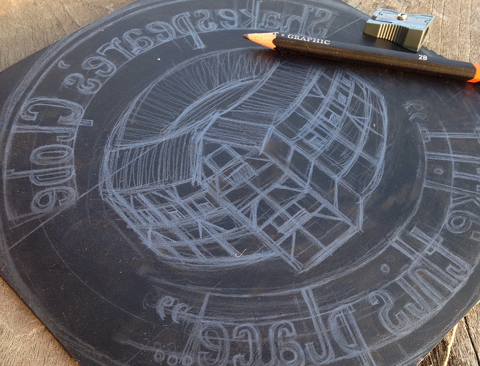 Initial drawing onto a block of lino A drawing of the Globe Theatre on a block of lino, the illustration reversed.