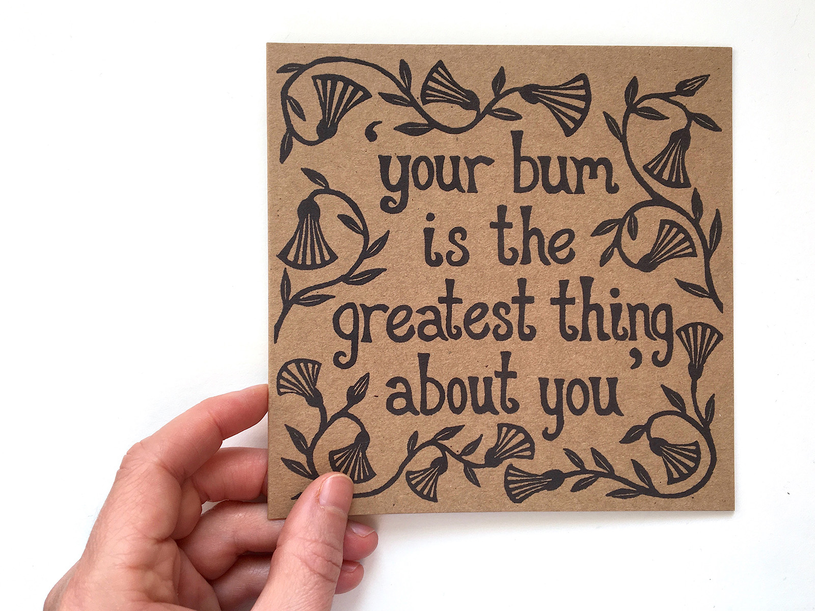 'Your bum is the greatest thing about you', from Measure For Measure. A square kraft paper greeting card with the text: Your bum is the greatest thing about you
