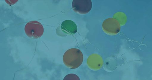 balloons floating towards clouds