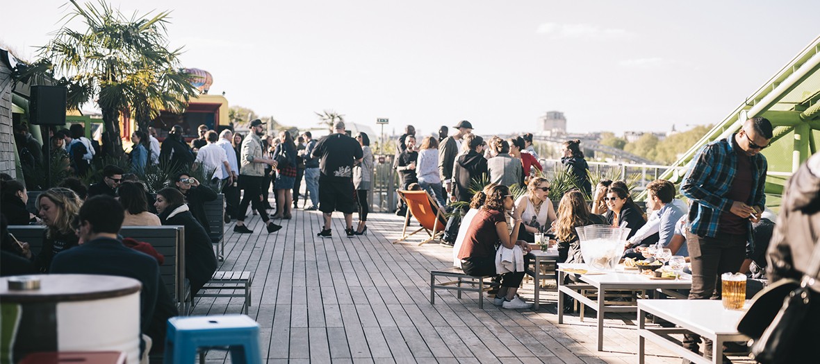 La terrasse du bar Café Oz, avec des personnes qui y boivent un verre.