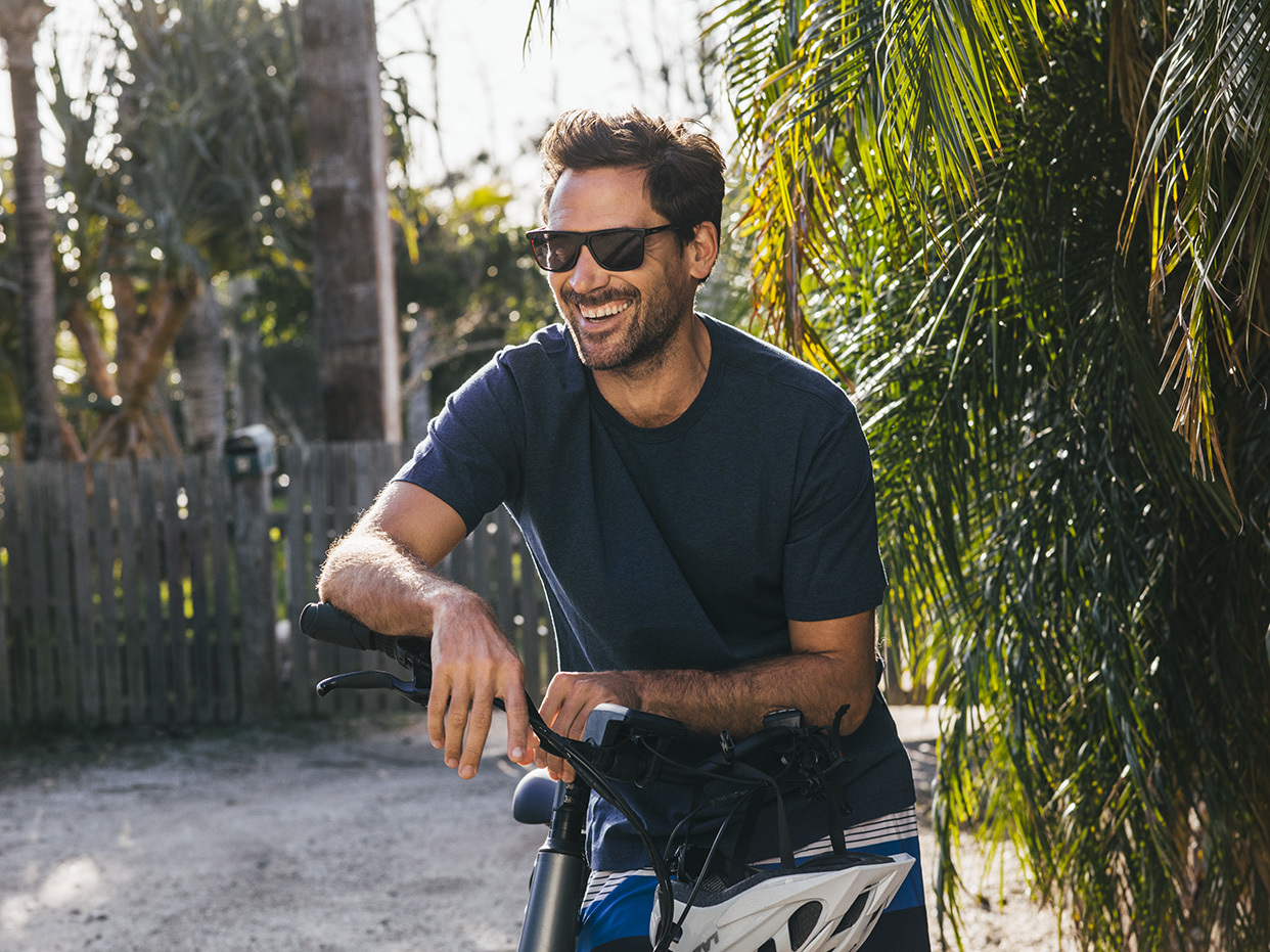 Man riding a bike wearing glasses