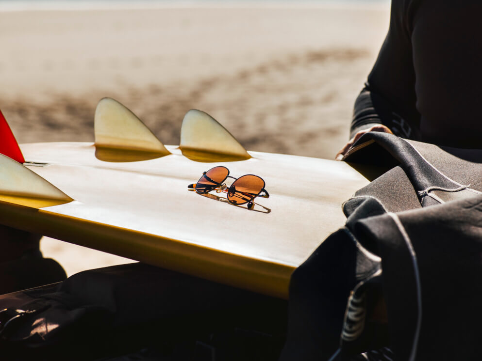 HACKETT SUN RX 01 resting on surfboard