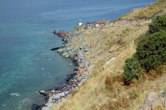Life jackets and rubber dinghies scatter the coast of Lesbos Island in Greece.