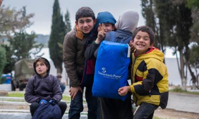 Children celebrate receiving a backpack filled with supplies from Samaritan’s Purse.