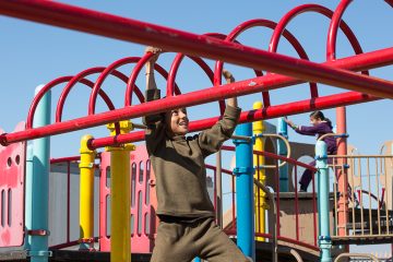 Displaced Yazidi children enjoy the playground at the Northern Iraq Community Center.