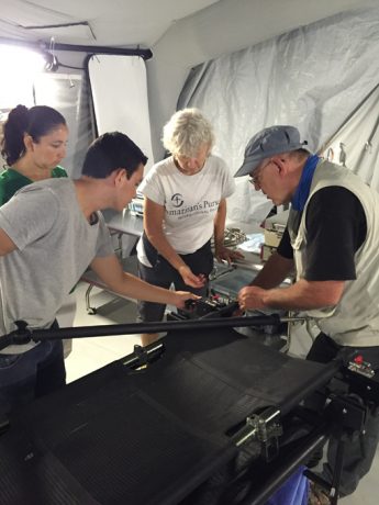 Jim Moore (right), Samaritan’s Purse technical support supervisor, goes over the functionality of the equipment in the emergency field hospital. He helped with the transfer of the mobile unit to Ecuador’s Ministry of Health.