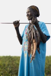 Regina, farms and fishes in Aweil. SP provided seeds, tools and training for this community farm